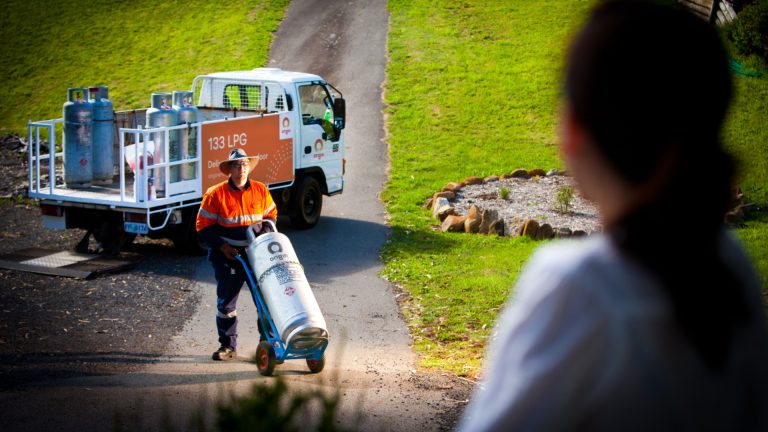 lpg-delivery-driver-wheeling-gas-bottle